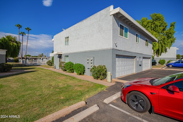 view of property exterior with a garage and a lawn