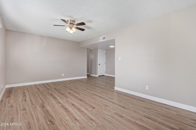 spare room featuring a textured ceiling, ceiling fan, and light hardwood / wood-style flooring