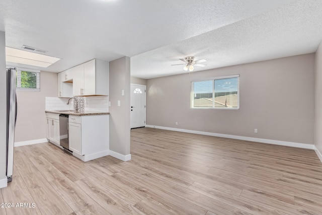 kitchen with white cabinets, light hardwood / wood-style floors, ceiling fan, and stainless steel appliances