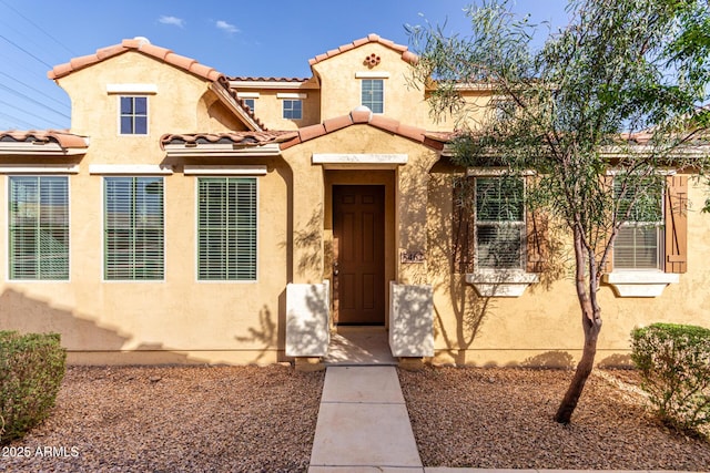 mediterranean / spanish-style house with a tiled roof and stucco siding