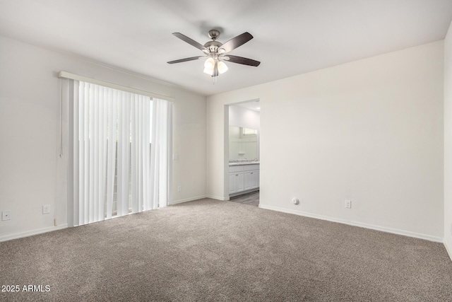 carpeted empty room with baseboards and ceiling fan