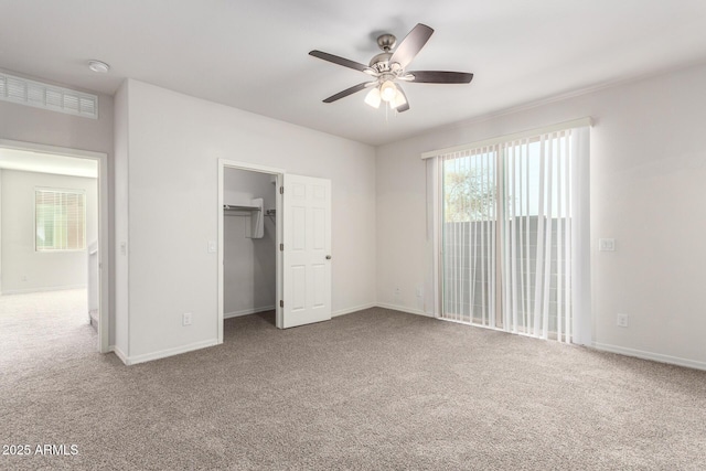 unfurnished bedroom featuring baseboards, visible vents, carpet floors, and ceiling fan