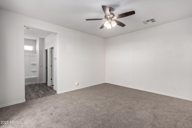 carpeted empty room featuring visible vents, baseboards, and a ceiling fan