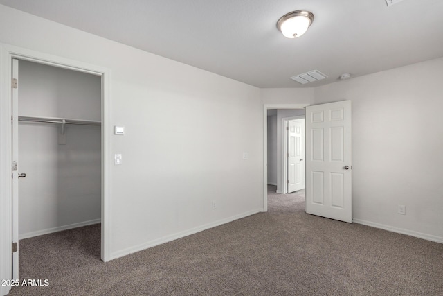 unfurnished bedroom with visible vents, carpet floors, and a spacious closet