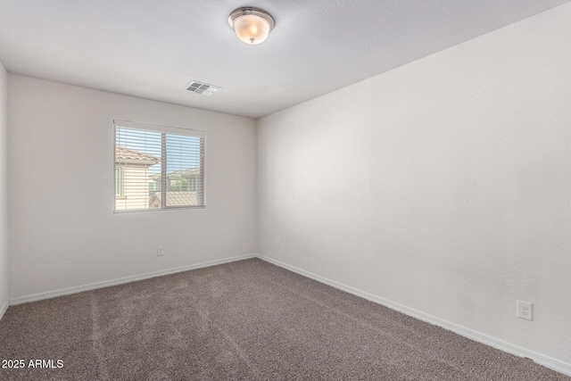 carpeted empty room with baseboards and visible vents