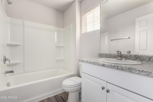 full bath featuring vanity, shower / bathing tub combination, toilet, and wood finished floors