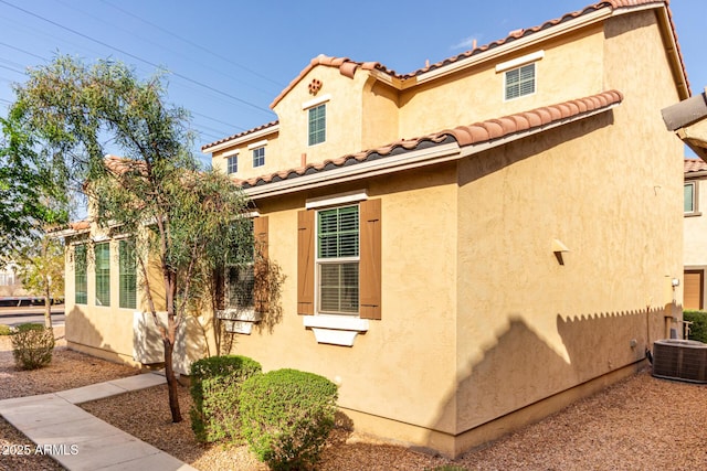 view of property exterior featuring central AC unit and stucco siding