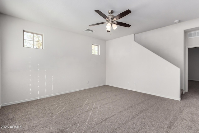 empty room featuring visible vents, a ceiling fan, baseboards, and carpet floors