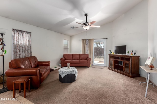 living area with a ceiling fan, light colored carpet, vaulted ceiling, and visible vents