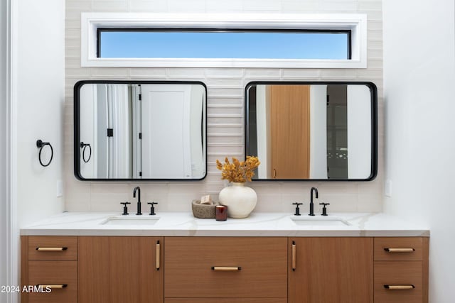 bathroom featuring vanity and decorative backsplash