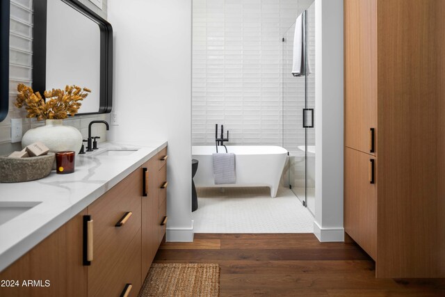 bathroom featuring vanity, wood-type flooring, and independent shower and bath