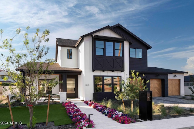 view of front of home with a front yard and a garage