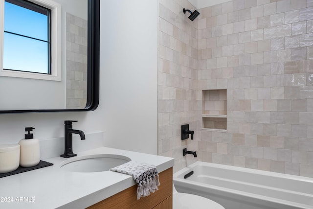 full bathroom with vanity, tiled shower / bath combo, and toilet