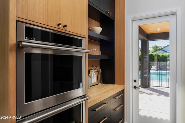 kitchen with butcher block countertops and stainless steel double oven