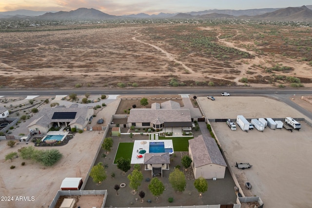 aerial view at dusk featuring a mountain view