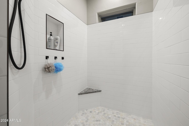 bathroom with tiled shower