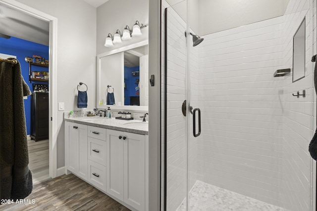 bathroom featuring vanity, hardwood / wood-style floors, and an enclosed shower