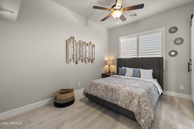 bedroom with ceiling fan and light wood-type flooring