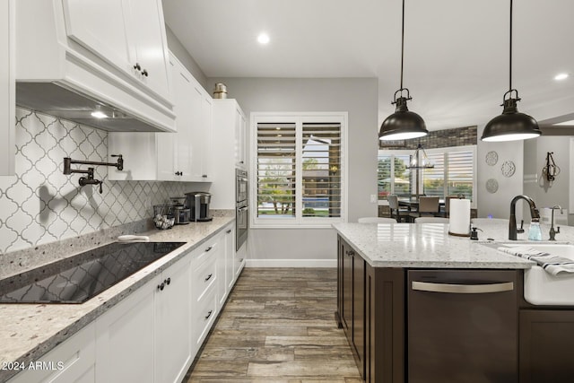 kitchen featuring white cabinetry, black electric stovetop, stainless steel dishwasher, and premium range hood