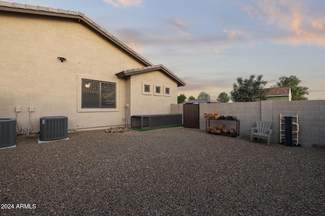 property exterior at dusk with central AC unit