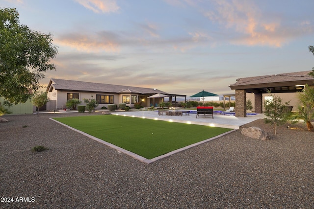 yard at dusk with a patio area