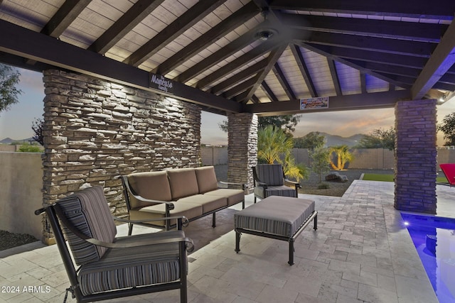 patio terrace at dusk with a gazebo and outdoor lounge area