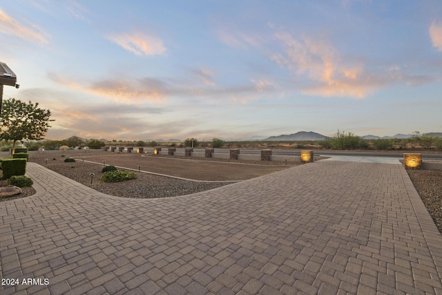 patio terrace at dusk featuring a mountain view