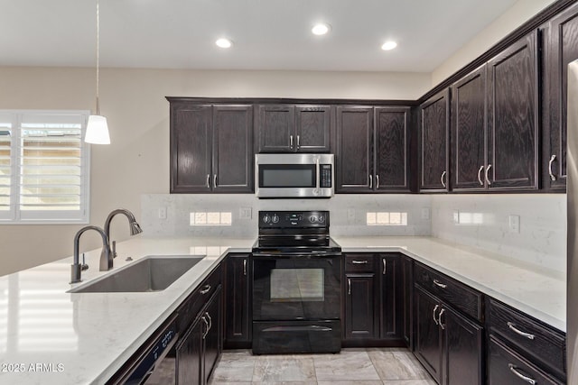 kitchen featuring sink, dark brown cabinets, black range with electric cooktop, pendant lighting, and decorative backsplash