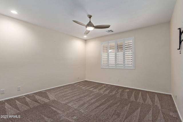 carpeted spare room with ceiling fan