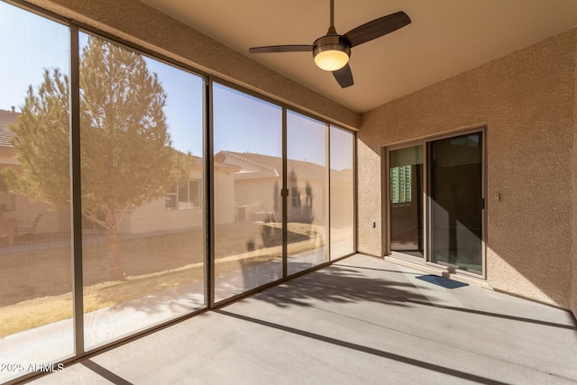 unfurnished sunroom with ceiling fan