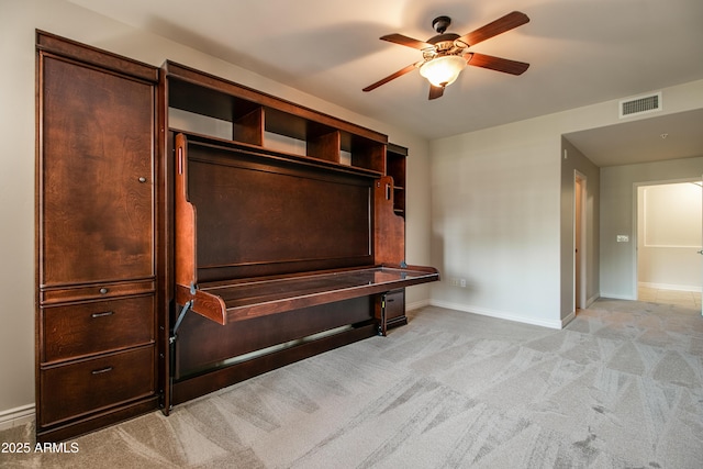 interior space with ceiling fan and carpet floors