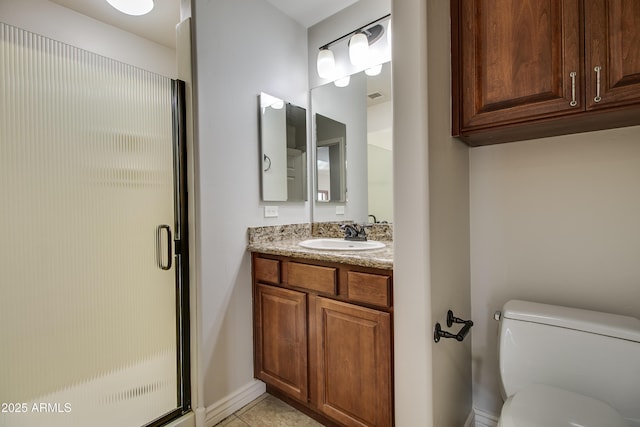 bathroom with tile patterned flooring, vanity, toilet, and a shower with door