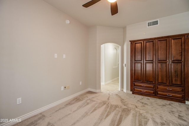 unfurnished bedroom with light colored carpet and ceiling fan