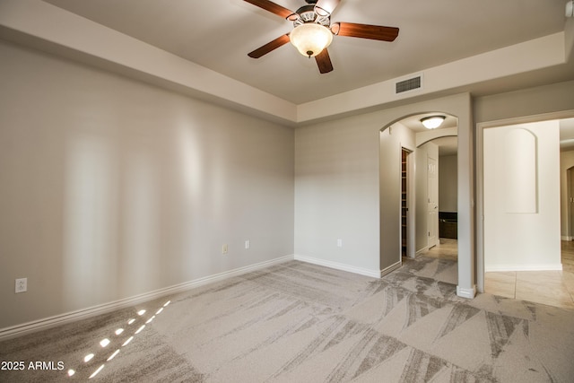 carpeted spare room with ceiling fan