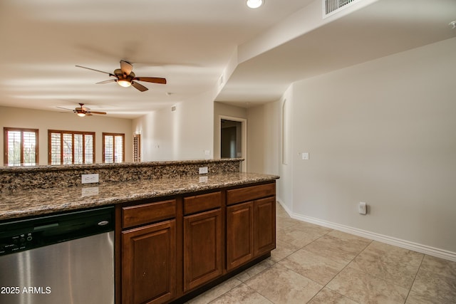 kitchen with dishwasher, ceiling fan, light tile patterned floors, and dark stone counters