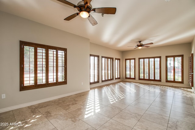 unfurnished room with light tile patterned floors and ceiling fan