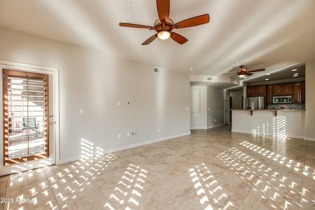 unfurnished living room featuring ceiling fan