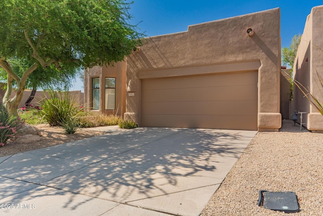 8324 E Cactus Wren Rd, Scottsdale, AZ 85250 - southwest-style home with stucco siding, driveway, and an attached garage
