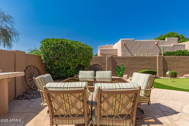 8324 E Cactus Wren Rd, Scottsdale, AZ 85250 - fenced backyard with a putting green, a patio, and outdoor dining space