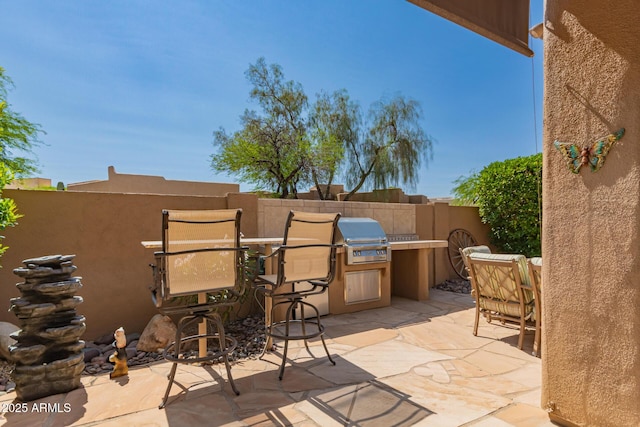 8324 E Cactus Wren Rd, Scottsdale, AZ 85250 - view of patio / terrace featuring an outdoor kitchen