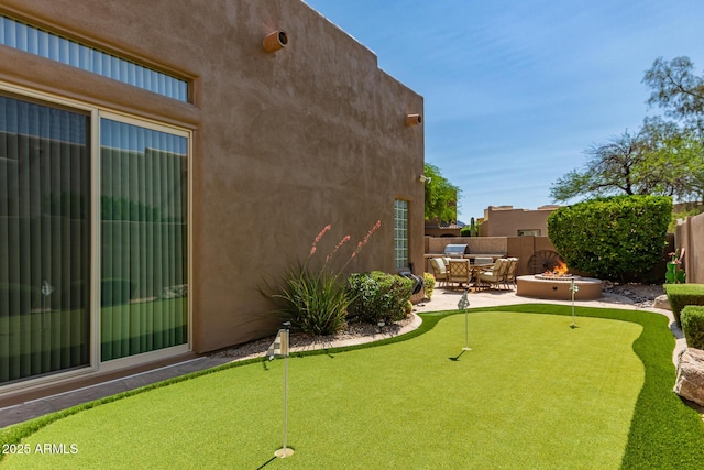 8324 E Cactus Wren Rd, Scottsdale, AZ 85250 - view of yard with a putting area, a patio area, and an outdoor fire pit
