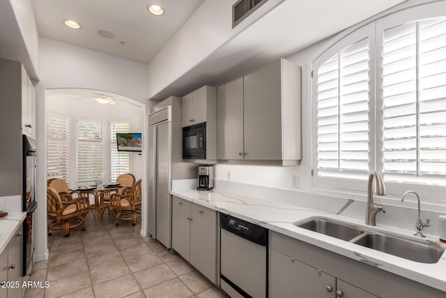 8324 E Cactus Wren Rd, Scottsdale, AZ 85250 - kitchen featuring built in appliances, gray cabinets, light tile patterned floors, light stone countertops, and recessed lighting