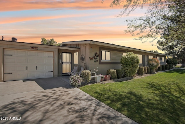 view of front of property with a garage, driveway, and a front lawn