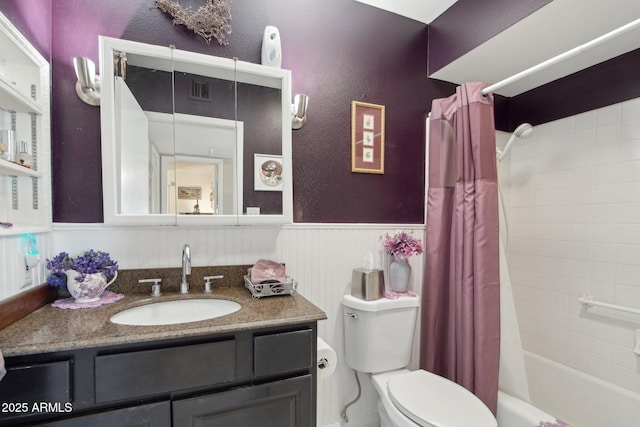 full bath with visible vents, wainscoting, toilet, shower / bathtub combination with curtain, and vanity