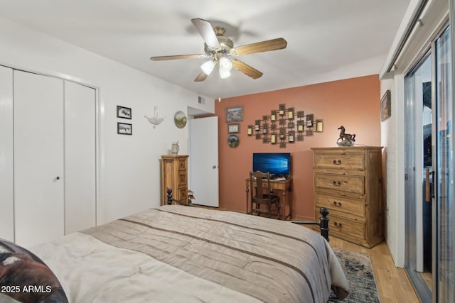 bedroom featuring ceiling fan, a closet, light wood-type flooring, and visible vents