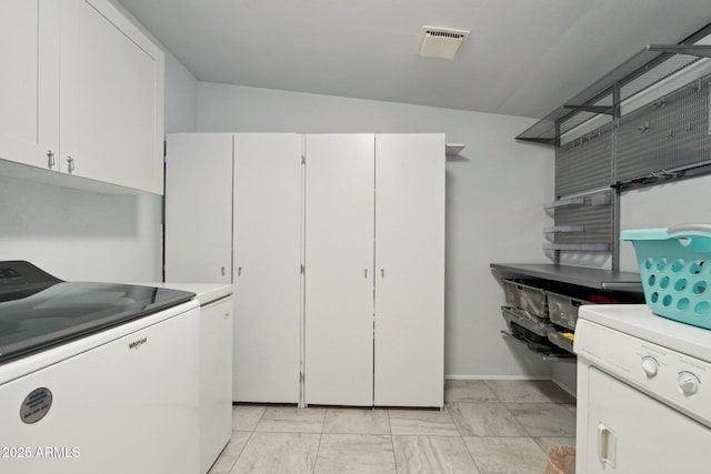 kitchen featuring white cabinetry, visible vents, light countertops, and washing machine and clothes dryer