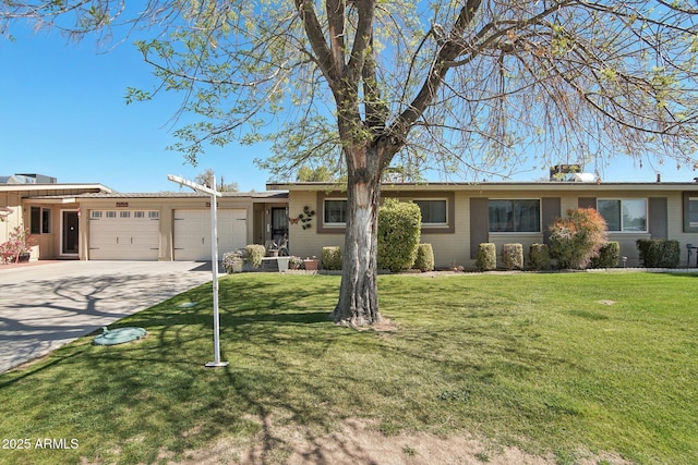 ranch-style house featuring an attached garage, driveway, and a front lawn