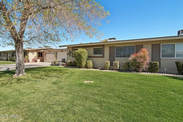 single story home with a garage, a front lawn, concrete driveway, and brick siding