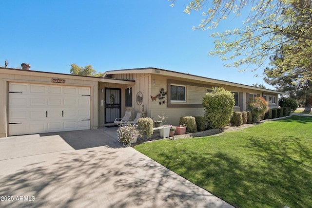 ranch-style home featuring concrete driveway, an attached garage, and a front yard