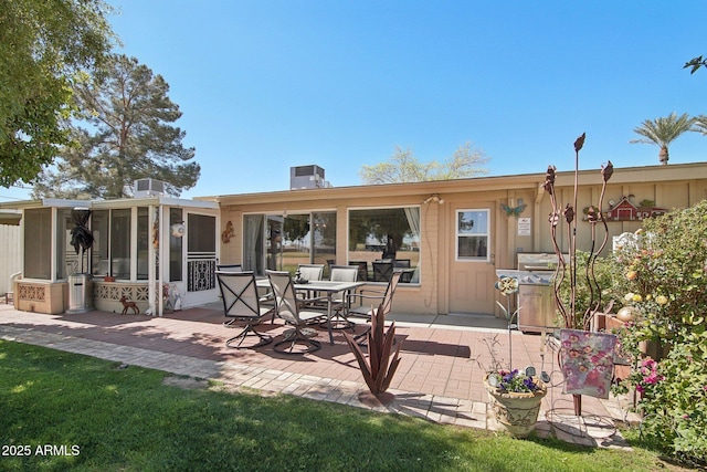 back of property featuring a patio area and a sunroom